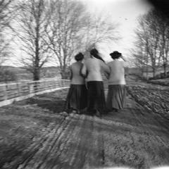 Three women walking down road
