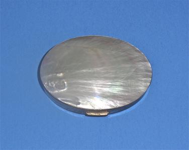 Oval compact with faux mother-of-pearl lid