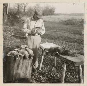 Aldo after successful pheasant hunt, examining the kill, October 1943