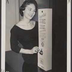 A young woman uses a vending machine to check for diabetes