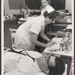 A student prepares to donate blood for the war effort