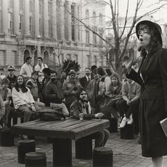 Woman preaches to a crowd outside