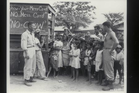 U.S. soldiers keeping order at distribution of food at GI mess, Dagupan, Pangasinan, 1945