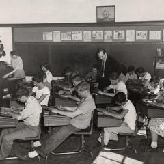 James Schwalbach in classroom with students drawing