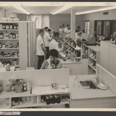A scene of a busy pharmacy serving auto workers