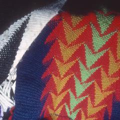 Close-up view of fingerwoven yarn sashes by Adeline Wanatee