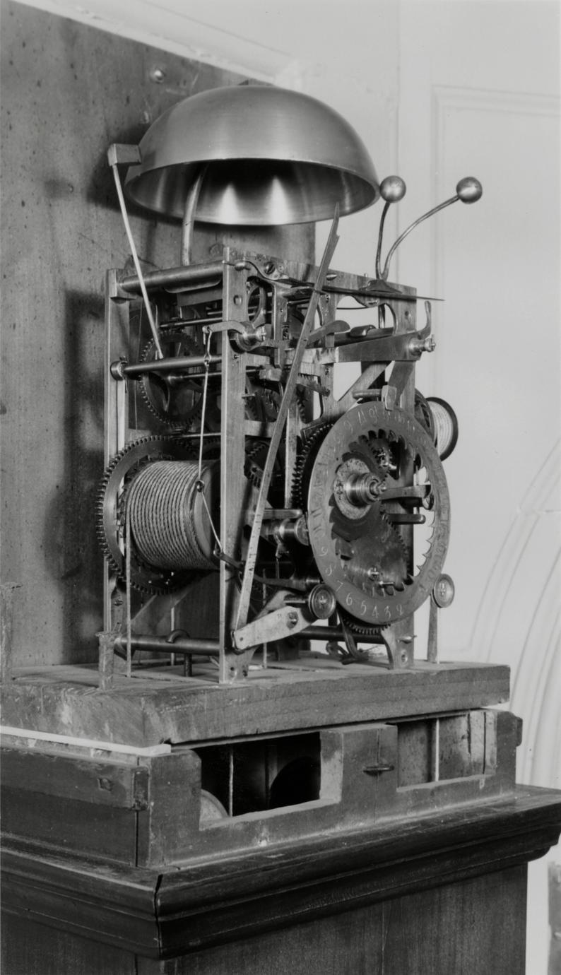 Black and white photograph of a gear system from an eight-day, strike, repeater, alarm clock.
