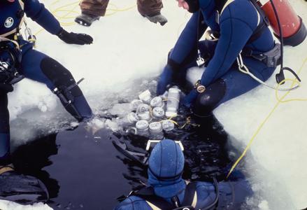 Divers entering frozen lake