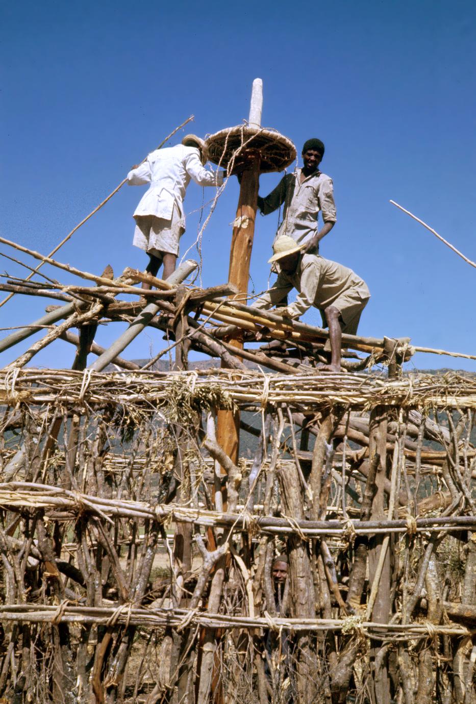 Men Working on Roof of House