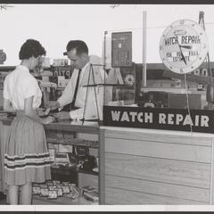 A customer gets help with watch repairs