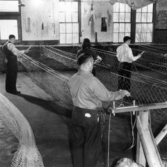 Men and women weaving with netting shuttles at Carron Net Co., Two Rivers, WI, February 1944