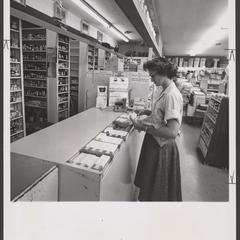 A customer shops for items at a pharmacy counter