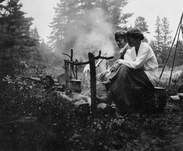 Two women at campfire at Les Cheneaux
