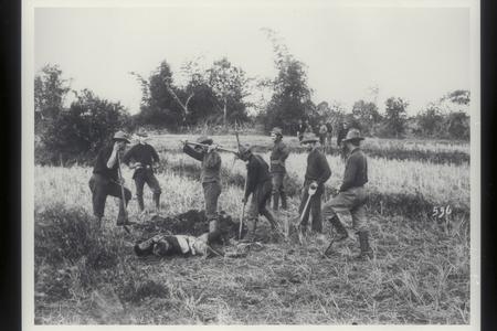 U.S. soldiers dig a grave for a fallen Filipino enemy, 1899