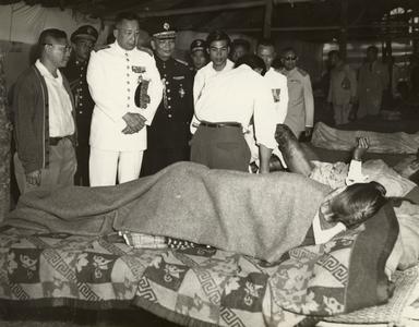 King of Laos visiting wounded soldiers
