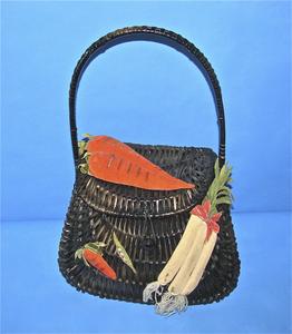 Black wicker purse covered with vegetables
