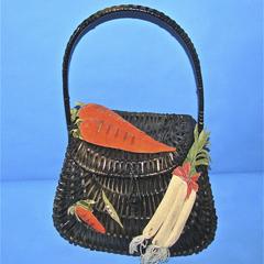 Black wicker purse covered with vegetables