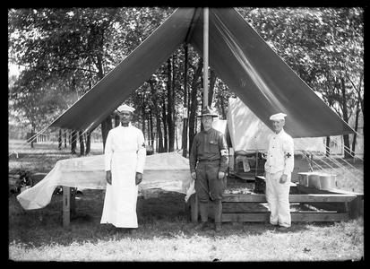 Military hospital personnel in front of hospital tent