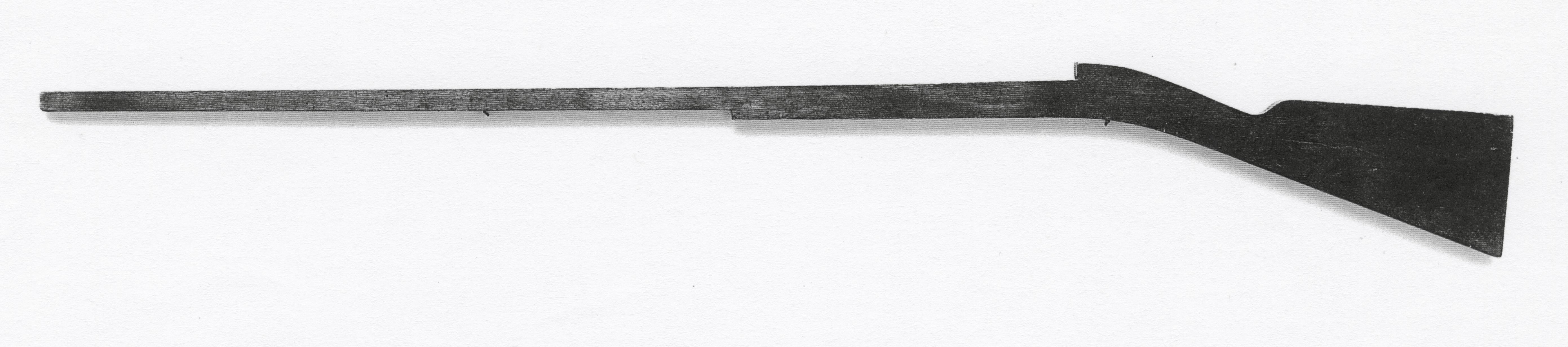 Black and white photograph of a gunstock pattern.