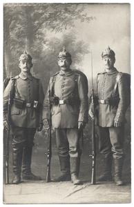 [Group portrait of three soldiers holding rifles with bayonets affixed]