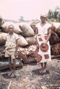 Woman and Son Selling Charcoal Along Roadside