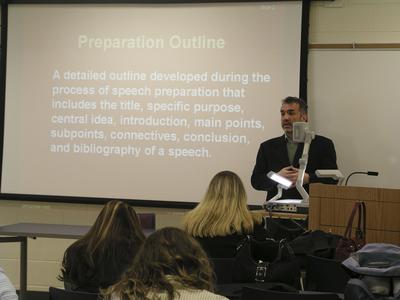 Professor explains a preparation outline to students