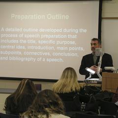 Professor explains a preparation outline to students