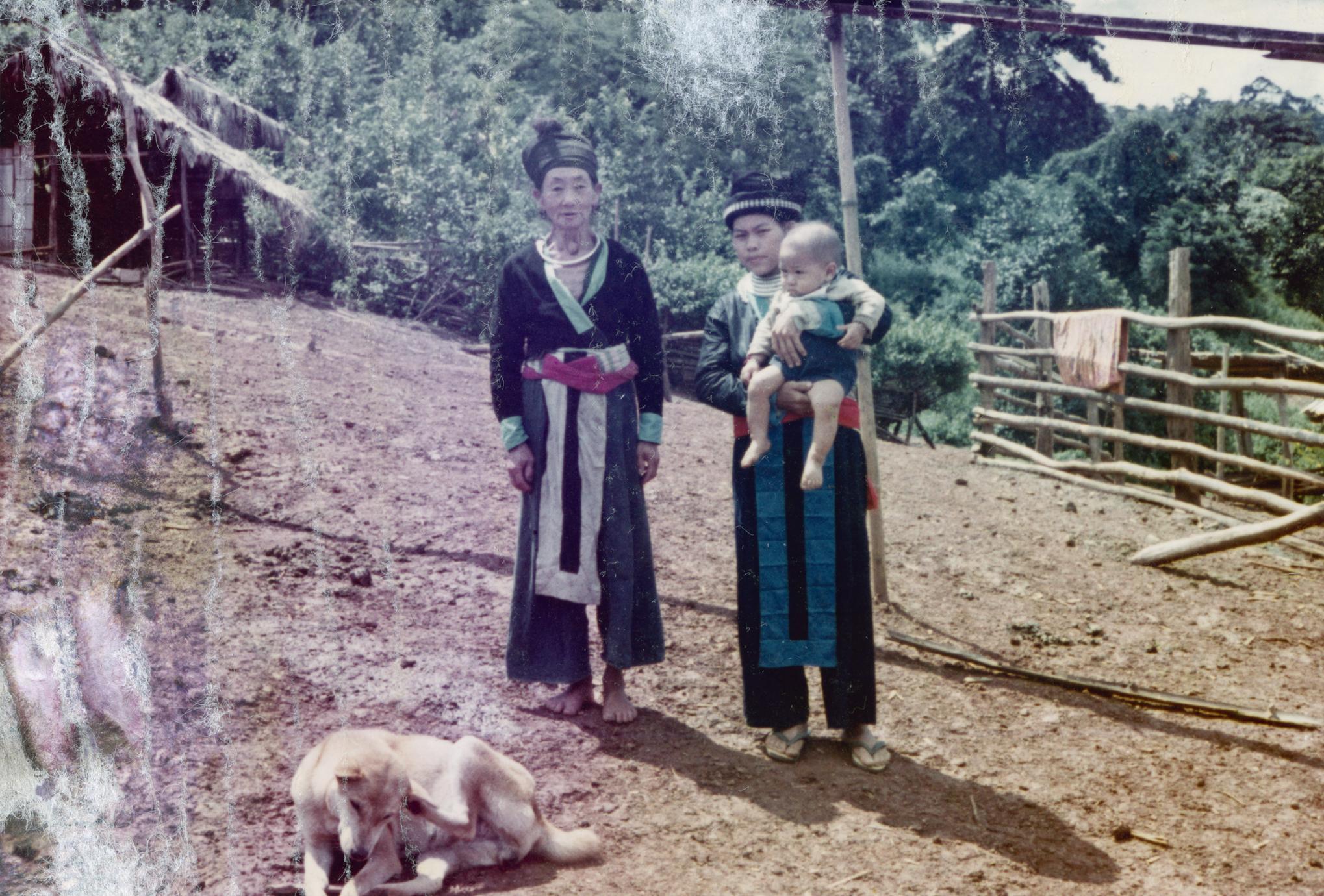 A White Hmong woman, baby and dog in Houa Khong Province