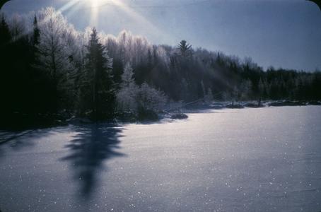 Sun and hoar frost at dawn in winter at Mystery Lake