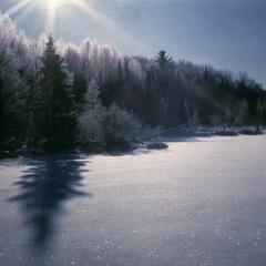Sun and hoar frost at dawn in winter at Mystery Lake