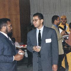 Two men talk at 1995 graduation reception