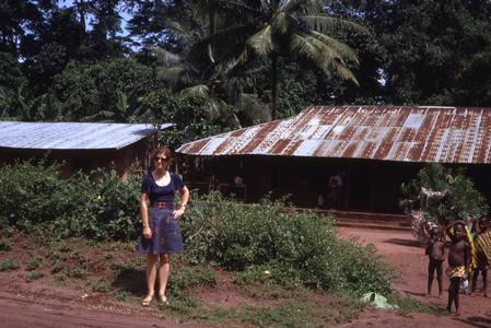 Woman in front of village