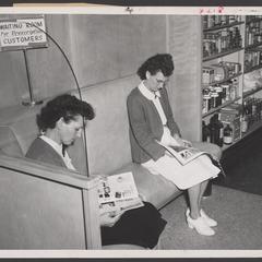 Two customers wait for their prescriptions to be filled