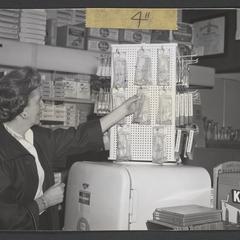 Woman selects a thermometer from a display