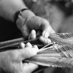 Adeline Wanatee fingerweaving a yarn sash