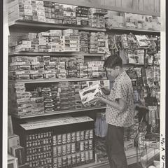 A young boy examines toys in the toy department