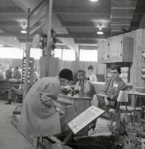 Woman Views the Herbs and Spices Display, College of Agriculture Flower Show, 1967