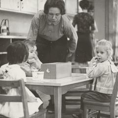 Woman and children looking at a box