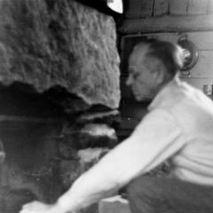 Aldo Leopold by shack fireplace