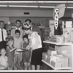 Children sample candy at a drugstore