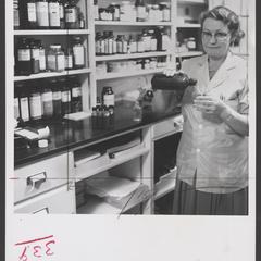 A pharmacist refills a liquid medication