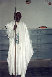 Descendant of Bakarijan Kone Holding the Bamana General's Spear in Village Museum