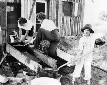 Nina Leopold, Jeannie Randolph, and Estella Leopold washing gravel and mixing it with cement for the shack fireplace