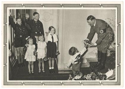 [Hitler receives gift of flowers from saluting Hitler youth and children]