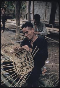 Lao men weaving baskets