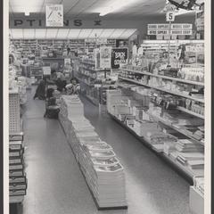 Children select school supplies from a drugstore display