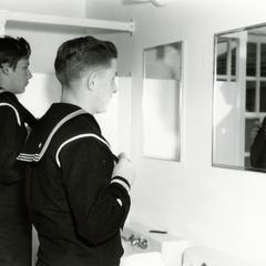 Coast Guard men in front of mirrors