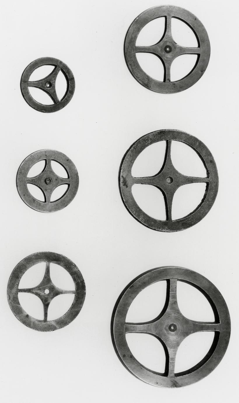 Black and white photograph of clock-wheel templates.