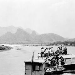 Barges linked together on Mekong traveling upstream to Pak Ou