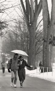 Students take a stroll on campus on a rainy day